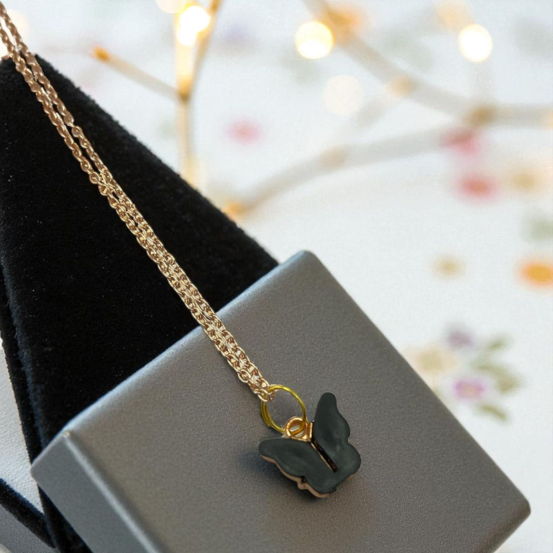 Gold-plated necklace featuring a black acrylic butterfly pendant